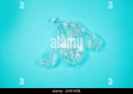 Used rumpled plastic bottles on a blue background. Ecology problem. Top view. Copy space. Top view Stock Photo