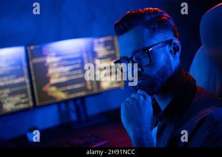 Profile portrait of serious minded person arm touch chin decide solution late night loft room space Stock Photo