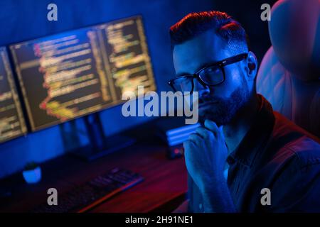 Photo of minded smart clever programmer hand on chin look camera ponder contemplate business center Stock Photo