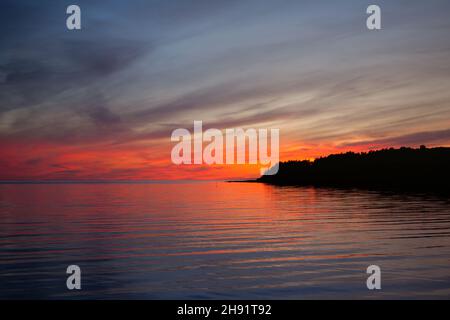 red and blue sunset on the sea - burning dramatic sky at evening in baltic sea Stock Photo
