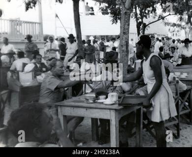 Ghana / The Gold Coast. Rare street scene of Accra in 1946. RAF / British military personnel being served in an outdoor cafe. Stock Photo