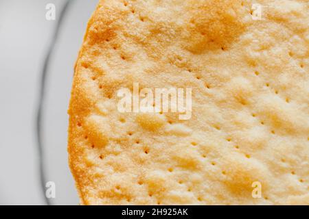 Texture of baked crumpets cakes made of puff pastry for cake. Semi-finished product for cake, close up top view Stock Photo