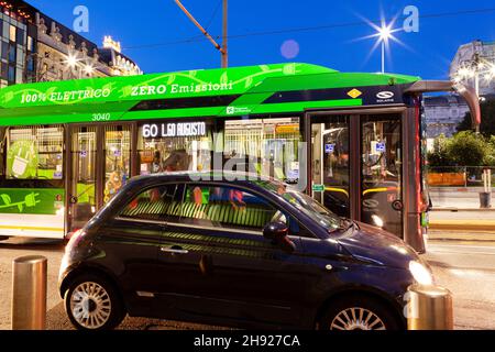 Milan, Italy - November, 04: Evening view of a car and ATM bus (Azienda Trasporti Milanesi S.p.A - Transport Company of Milan) on the urban traffic on Stock Photo