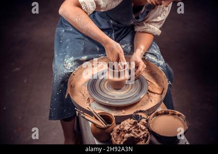 Processing clay ware and making dishes, process. Ceramics of handwork and clay ware on the potter's wheel. Stock Photo