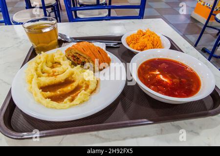 Food in an eatery in Almaty, Kazakhstan. Roulade with mashed potatoes, Borscht soup and carrot salad. Stock Photo
