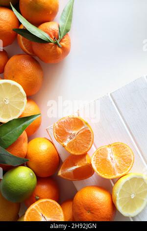 Flat lay composition with different citrus fruits on white background. Copy space. Directly above. Stock Photo