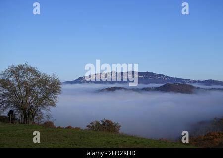 beautiful images of the mountain where the state of San Marino rises, rising from the clouds. Beautiful because it looks like a ship in a sea of fog. Stock Photo