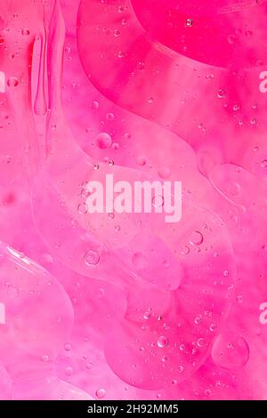 Photo of oil on a water surface with bubbles. soft pink. Abstract colorful background. Macro close-up, Stock Photo