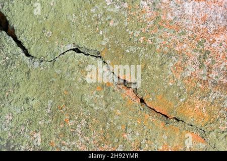 Crack on old, weathered, dirty, green with mold broken wall texture background. Stock Photo