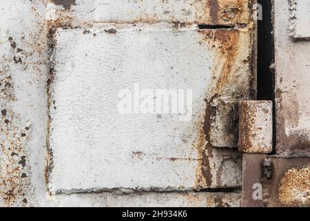 Old door installation system welded point hinge, dirty iron worn plates. Stock Photo