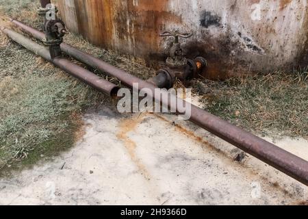 Discharge of chemical toxic waste from an old pipeline. Pollution of the environment and ecology. Dangerous and dirty production plant. Stock Photo