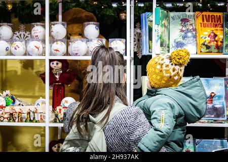 Bucharest, Romania. 3rd Dec. 2021. Mother and her child looking for presents Stock Photo