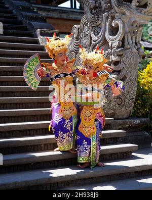 Indonesia. Bali. Two young Balinese female dancers on temple steps. Stock Photo