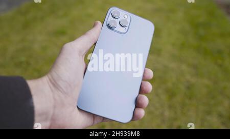 MOSCOW, RUSSIA-NOVEMBER, 2020: Close-up of new iPhone in your hand. Action. Man holds luxury iPhone with stylish case and three cameras. New iPhone mo Stock Photo