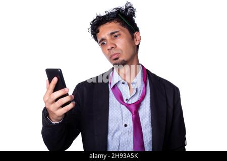 Businessman checks his cell phone at the end of the workday. Young adult young man finishes a day at work, isolated on all white background. Stock Photo