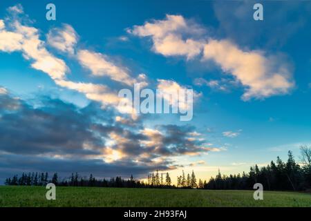 Dramatic skies at sundown over rural farm fields. Stock Photo