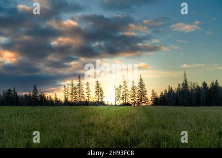 Dramatic skies at sundown over rural farm fields. Stock Photo