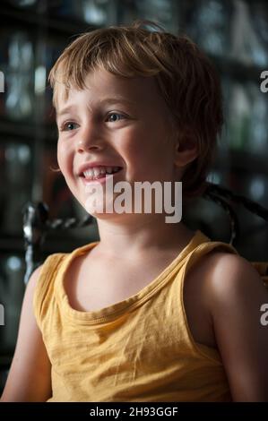A 4-year-old boy reacts while he watches a cartoon on a computer screen at home. Stock Photo