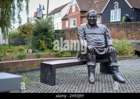 Bronze statue of comedian Dave Lee sitting on a bronze bench by Dominic Grant outside Marlow Theatre in Canterbury. Stock Photo