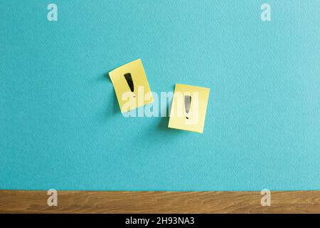 Sticky notepad with exclamation mark on blue wall. Thinking, solution, business, idea concept Stock Photo