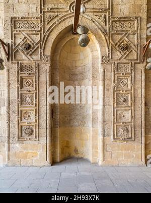 Engraved decorated stone wall with embedded niche in Mamluk era historical public mosque of Sultan al Muayyad, Cairo, Egypt Stock Photo