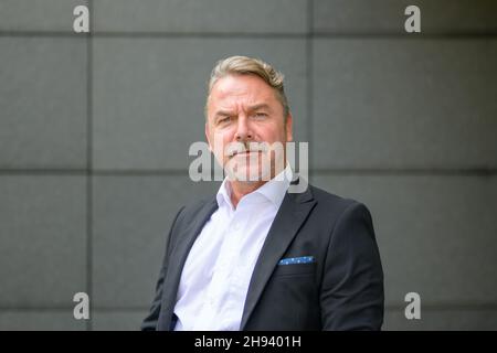 Side view portrait of a serious handsome middle-aged man making a funny face Stock Photo