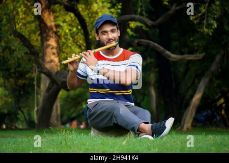 boy playing bansuri flute indian wind instrument Stock Photo