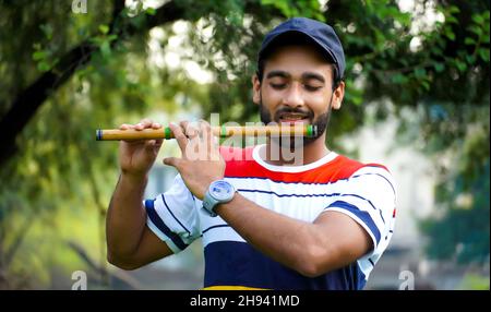 playing bansuri flute indian wind instrument Stock Photo