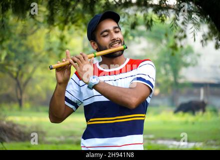 playing bansuri flute indian wind instrument Stock Photo