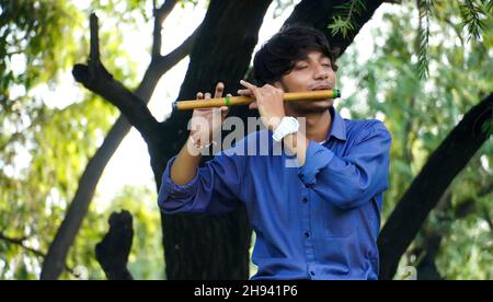 playing bansuri flute indian wind instrument Stock Photo