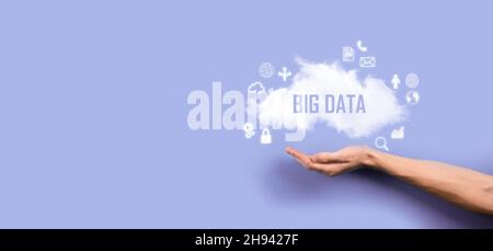 Businessman holds the inscription , word BIG DATA. Padlock , brain ,man, planet,graph, magnifier, gears, cloud, grid, document, letter, phone icon Stock Photo