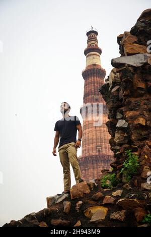 indian young handsome man at historical palace qutub minar travel in india image Stock Photo