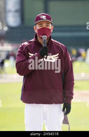 A fan of former New York Yankees outfielder and designated hitter Hideki  Matsui wears a jersey bearing his nickname Godzilla while taking  photographs of batting practice at Yankee stadium before a baseball