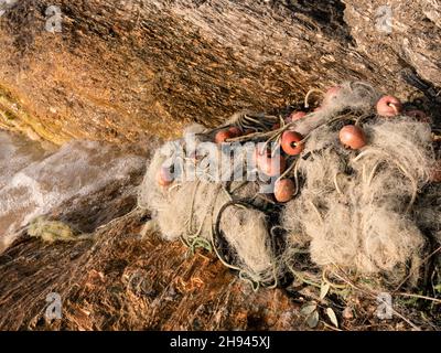 Old, Discarded Fishing Net Disposed on the shore at Lake Garda, Italy Stock Photo