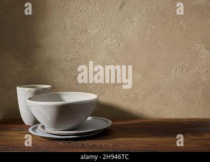 empty ceramic tableware on brown wooden shelf Stock Photo