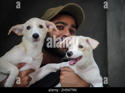 a dog lover young boy with 2 dogs happy and smiling - selective focus image Stock Photo