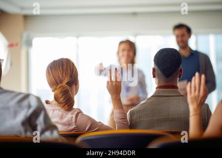 Young participants having discussion at a business lecture in a working atmosphere in the conference room. Business, people, meeting, company Stock Photo