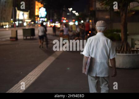 old man walking at the street at night Stock Photo