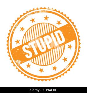 STUPID text written on orange grungy zig zag borders round stamp. Stock Photo