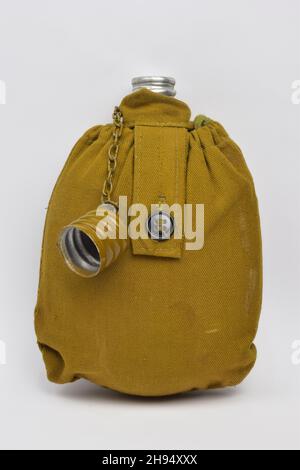 Military khaki lined liquid flask with open lid on chain on white clipping background Stock Photo
