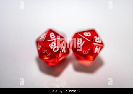 Closeup of two red twenty-sided dice on a white background Stock Photo