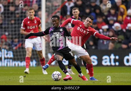 Nottingham Forest's Braian Ojeda battles for the ball with Peterborough United's Siriki Dembele, during the Sky Bet Championship match at the City Ground, Nottingham. Picture date: Saturday December 4, 2021. Stock Photo