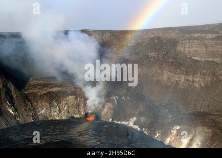 Kapoho, United States of America. 08 October, 2021. A rainbow forms around the fissure on the west wall of Halemaumau, at Kilauea summit inside Hawaii Volcanoes National Park, October 8, 2021 in Kapok, Hawaii. Lava fountaining at multiple fissure locations on the base and west wall of the crater continued, and a lava lake is growing within the volcanic crater.  Credit: USGS/USGS/Alamy Live News Stock Photo