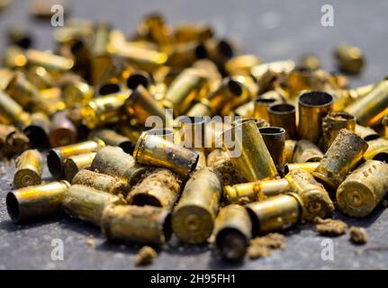 Fired golden bullets laying on the table Stock Photo