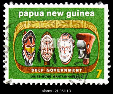 MOSCOW, RUSSIA - OCTOBER 24, 2021: Postage stamp printed in Papua New Guinea shows Native carved heads, Self-government serie, circa 1973 Stock Photo