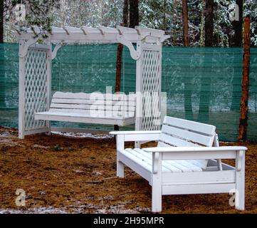 Swing and bench for rest and relaxation in the forest. Stock Photo