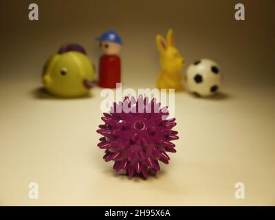 Conceptual image of the NCOV virus on the background of children toys. Stock Photo