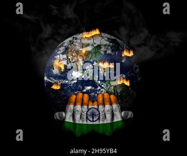 Hands painted with Indian flag holding stressed planet in crisis. Concept of the role of India in climate crisis; natural disasters, global warming, a Stock Photo