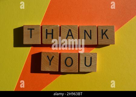 Thank You, words in wooden alphabet letters isolated on bright and colourful background Stock Photo