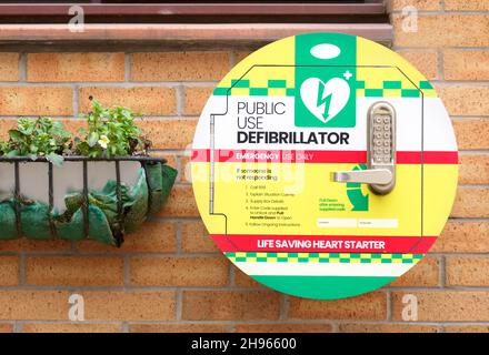 Defibrillator AED on wall in public space for emergency heart resuscitation Stock Photo